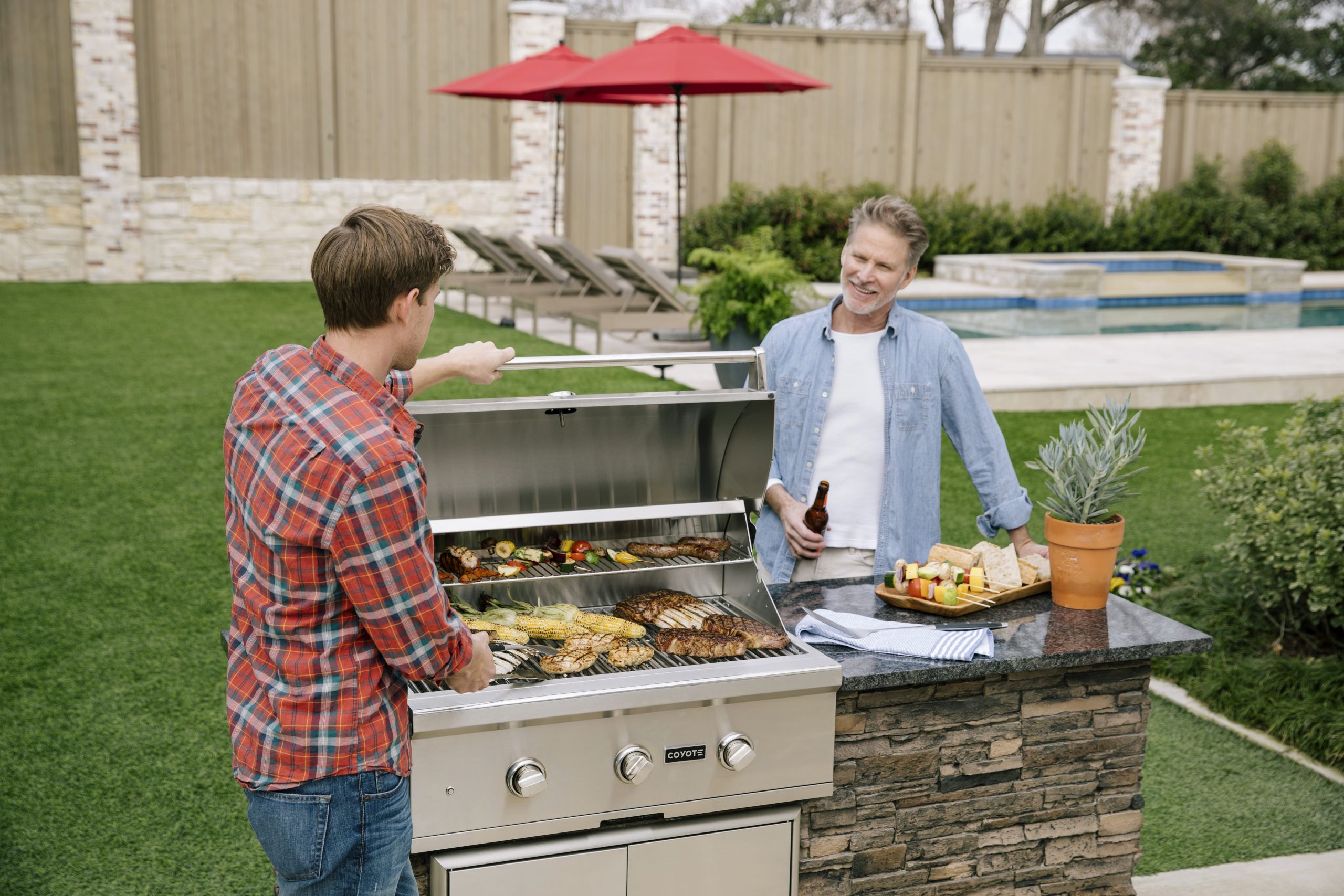 Two Men Grilling and Talking by the Pool