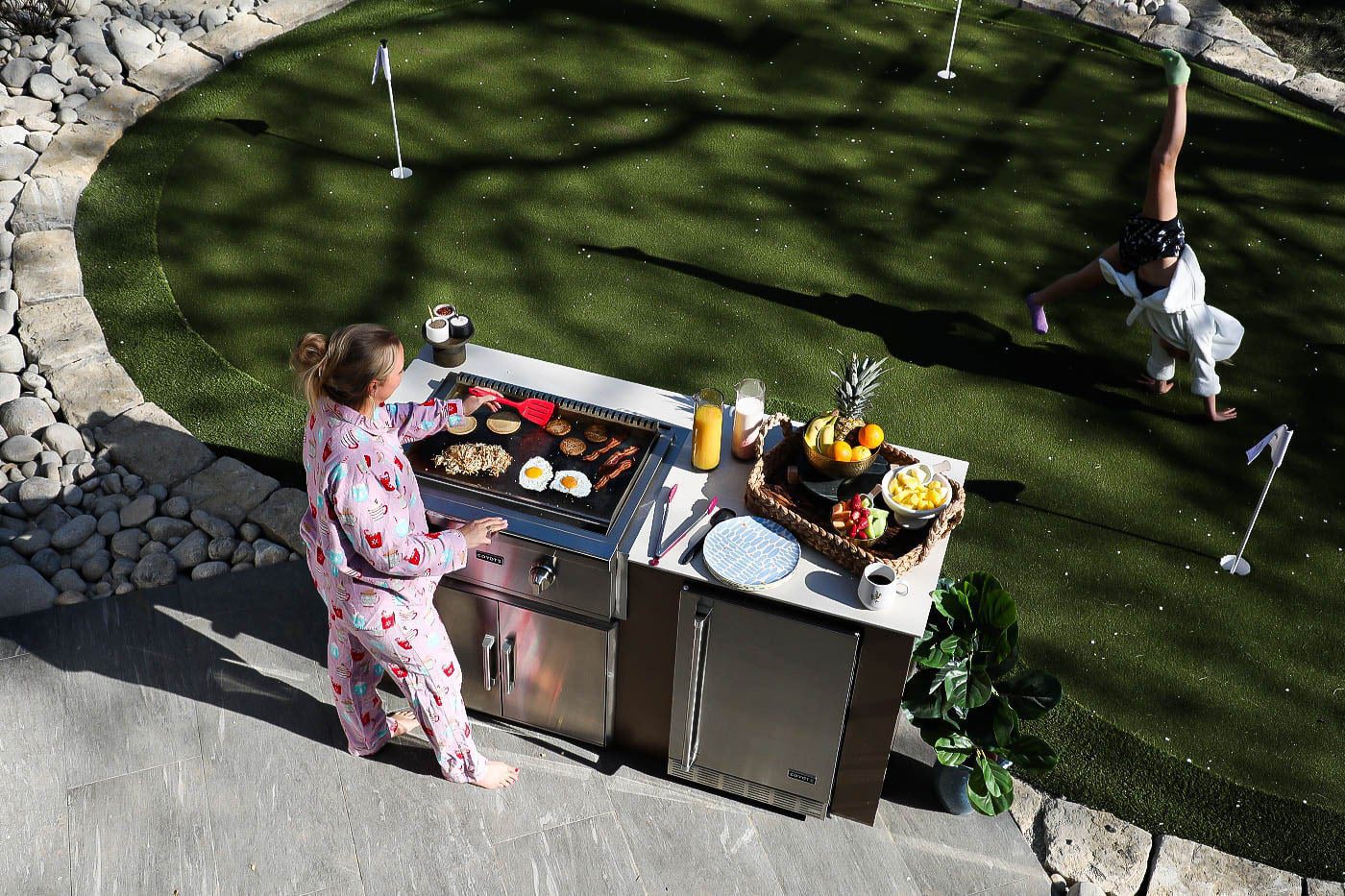 Woman Cooking on Coyote's Flat Top Grill