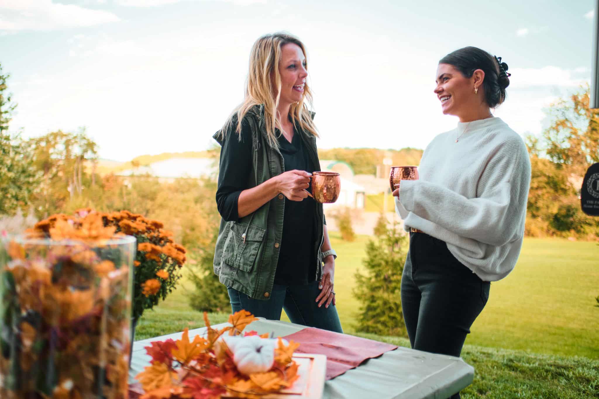 Two Women Drinking Apple Cider in Autumn