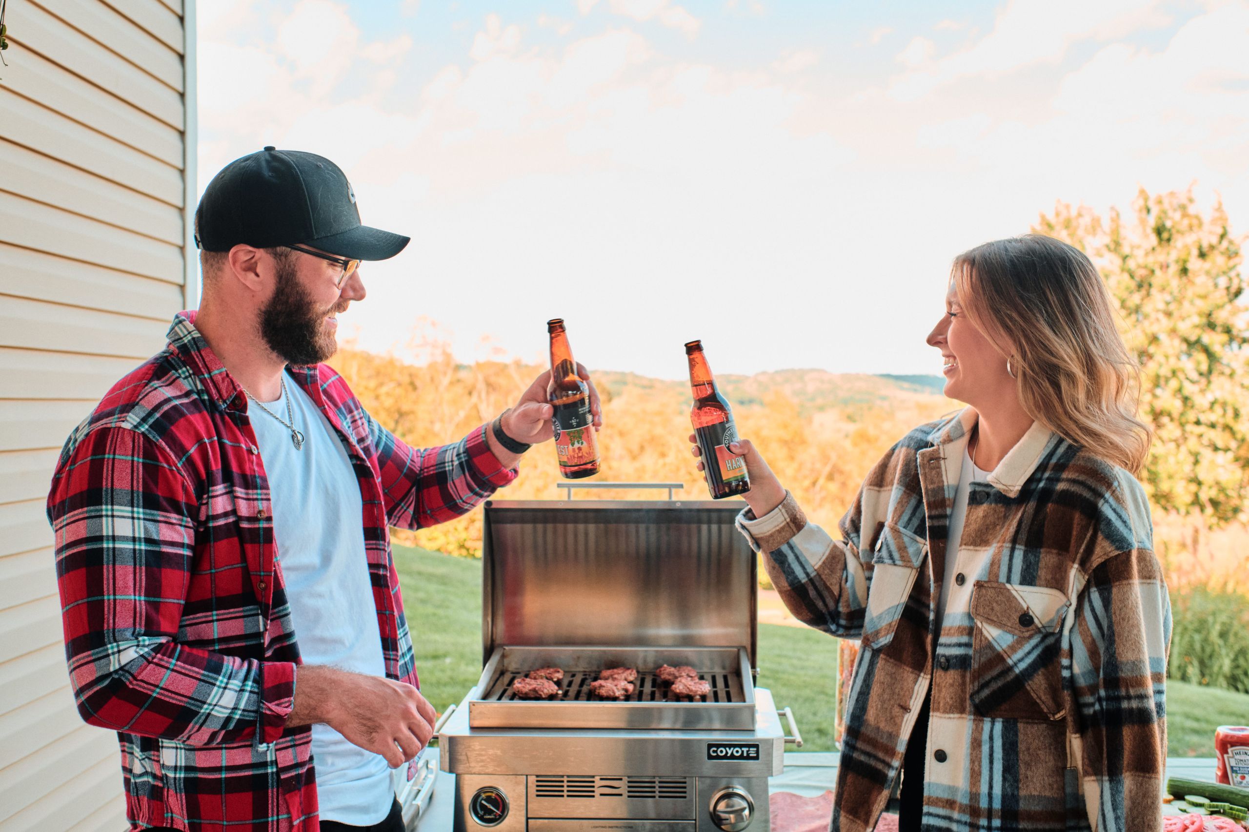 Man and Woman Grilling Burgers